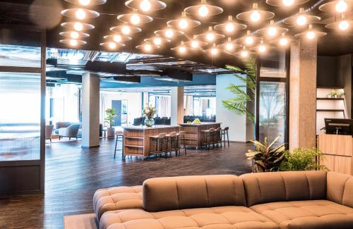 an office lobby with a couch and a table at Quality Hotel Grand, Borås in Borås