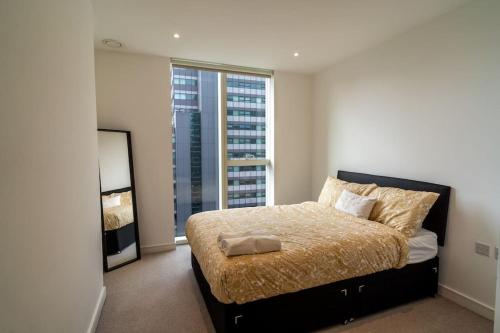 a bedroom with a bed and a large window at Luxury Flat Croydon in Croydon