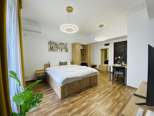 a bedroom with a bed and a desk at New City Studios with Balcony in Bucharest