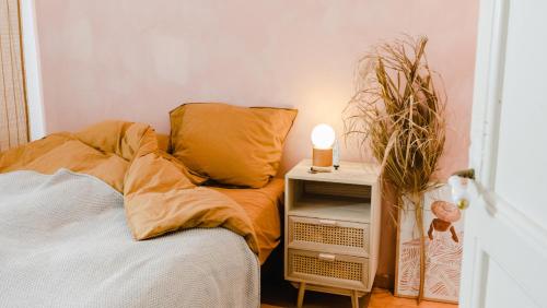 um quarto com uma cama e uma mesa de cabeceira com uma vela em KDC House em Garut