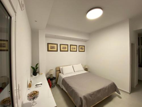 a small bedroom with a bed and a table at Modern studio apartment B in Athens