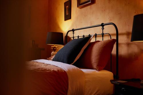 a bedroom with a bed with pillows on it at Clifton Homestead in Ranelagh