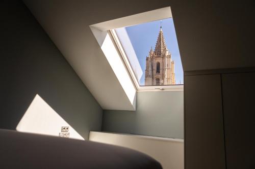 a view of a church from a room with a window at Principia Suites in León