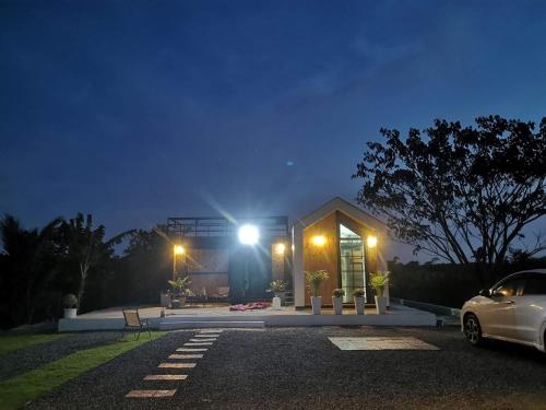 a car parked in front of a house at night at Cana Garden House 1 โฮมสเตย์ in Ban Khok