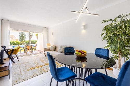 a living room with a table and chairs at Apartment Henry Matisse, swimming pool in Sagres