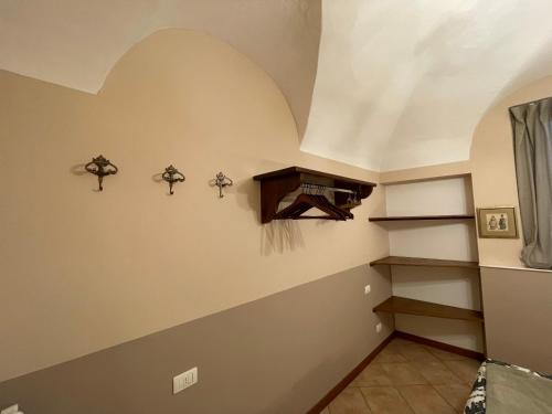 Habitación con una pared con estanterías y techo. en Lantica Filanda, en Cima