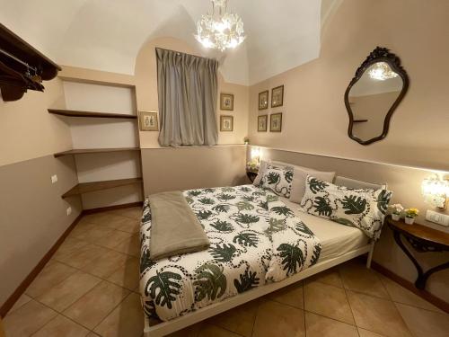 a bedroom with a bed and a desk and a mirror at Lantica Filanda in Cima