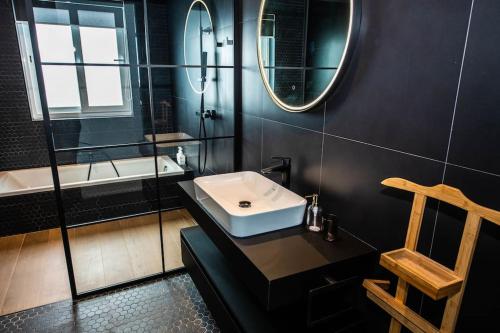 a bathroom with a sink and a mirror at Jaysky penthouse on Etna Street in Mellieħa