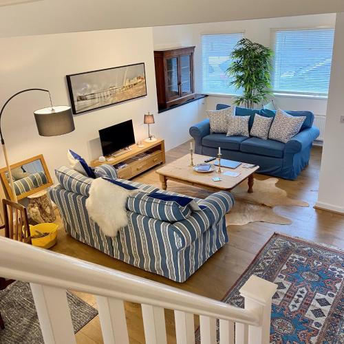 a living room with two couches and a tv at Skipper’s Cottage - Perfect for Cardiff & Penarth in Cardiff