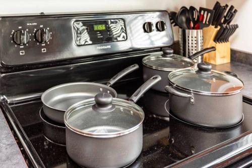 a group of pots and pans on a stove at Centric Modern Loft w/ King Beds in Rochester