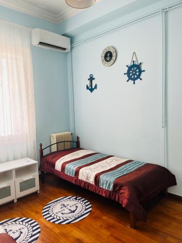 a bedroom with a bed and a clock on the wall at Sea voyage in Nafplio