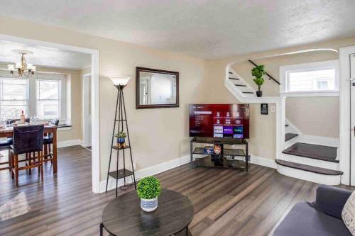 a living room with a table and a dining room at Fabulous House near Airpt/DwTN/UofR in Rochester