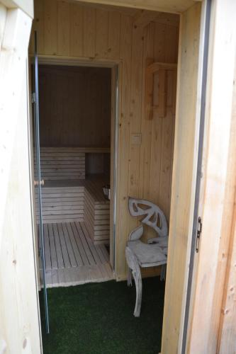 a sauna with a chair in a wooden cabin at Mountain chalet SmoLenisko domek w górach in Nowy Targ