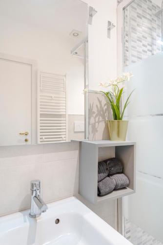 a white bathroom with a sink and a mirror at Pantheon Caravaggio's House in Rome
