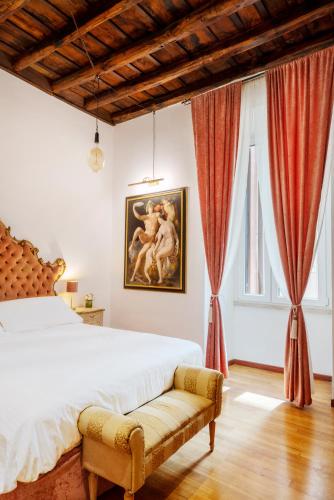 a bedroom with a bed and a painting on the wall at Pantheon Caravaggio's House in Rome