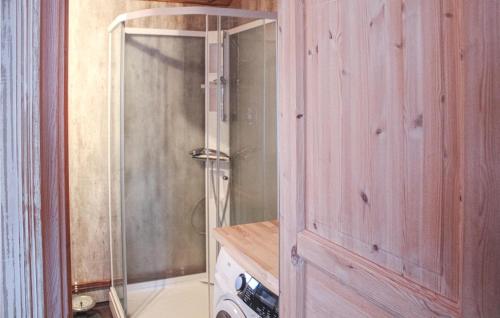 a bathroom with a shower and a wooden door at Cozy Home In Tuddal With Kitchen in Tuddal