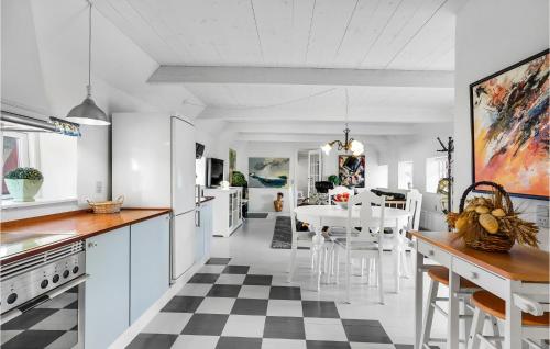 a kitchen with a black and white checkered floor at One-Bedroom Apartment In Storvorde in Storvorde