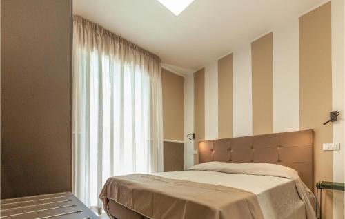 a bedroom with a bed and a large window at Trilo Sup in Alba Adriatica