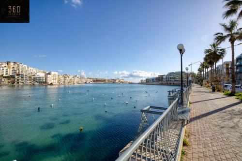 a river with people swimming in the water at Stunning 3BR w/Country View Apartment in M'Scalak by 360 Estates in Marsaskala