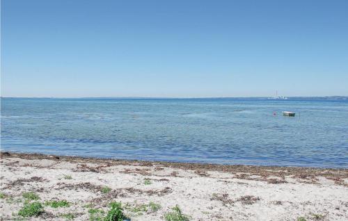 a beach with a boat in the water at Three-Bedroom Holiday Home In Knebel in Knebel