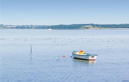 a small boat sitting in the middle of a body of water at Three-Bedroom Holiday Home In Knebel in Knebel