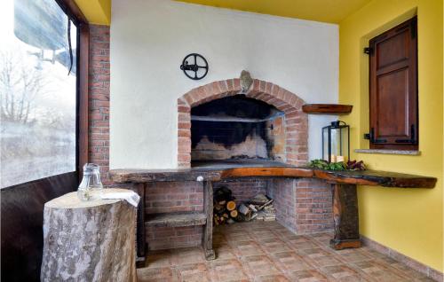 a brick fireplace in a room with a table at Amazing Home In Adamovec With Sauna in Adamovec