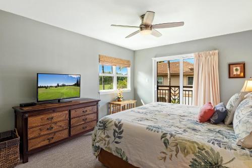 a bedroom with a bed and a flat screen tv at Newly Updated Condo At Waikoloa Colony Villas in Waikoloa