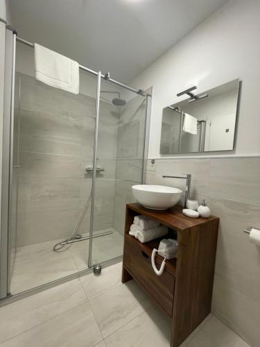 bagno con lavandino e doccia in vetro di Ai Tre Garofani B&B a Trento