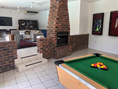 a living room with a pool table and a fireplace at Villa Incognito in Clansthal