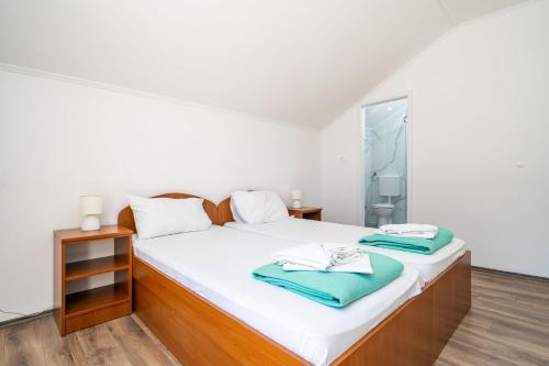 a bedroom with a bed with two towels on it at Guest House Daniela in Mlini