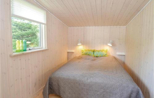 a bedroom with a bed in a room with a window at Cozy Home In Vggerlse With Kitchen in Bøtø By