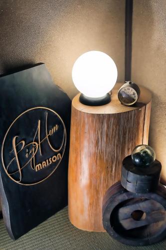 a lamp on top of a wooden table next to aperature at Bighem Maison 2 in Izumi-Sano