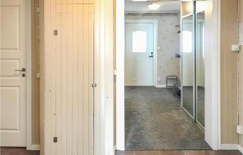 a hallway with a glass door and a mirror at Amazing Home In Torpshammar in Torpshammar