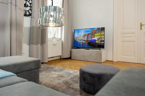 a living room with a flat screen tv on a wall at Turquoise inspired deluxe centrally located in Vienna