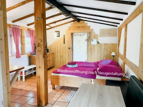 a bedroom with a bed in a room with wooden walls at Ferienhaus-Elisabeth Bungalow-Tom Bungalow-Peter in Reinhardtsdorf