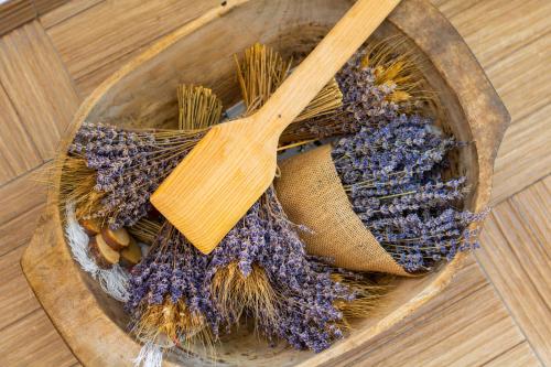 a wooden spoon sitting in a wooden bowl with lavender at Mai Danube in Eşelniţa