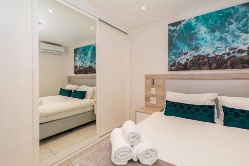 a bedroom with a bed with towels on it at Magnificent apartment 506 The Granger in Cape Town