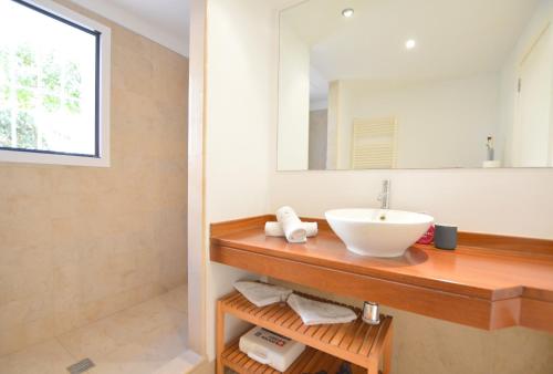 a bathroom with a sink and a mirror at Villa Sa Ràpita / Es Trenc in Campos