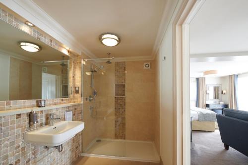 a bathroom with a sink and a shower at Park Farm Hotel in Norwich
