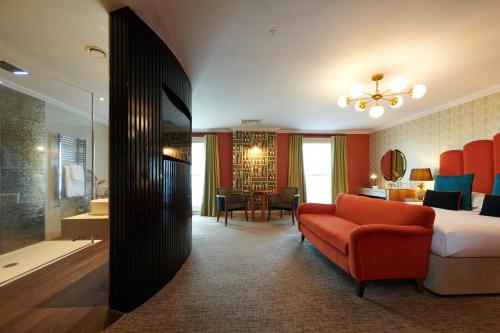 a hotel room with a bed and a couch at Park Farm Hotel in Norwich