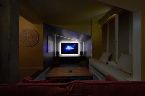 a living room with a couch and a tv at Park Farm Hotel in Norwich