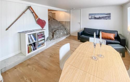 a living room with a wooden table and a couch at Stunning Apartment In Arendal With Wifi in Arendal