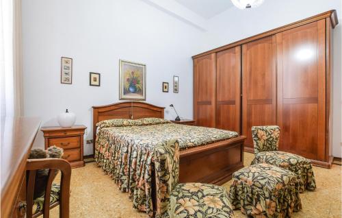 a bedroom with a bed and two chairs at Nice Apartment In Camaiore With 2 Bedrooms And Wifi in Camaiore