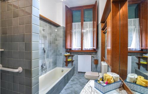 a bathroom with a tub and a toilet and a sink at Nice Apartment In Camaiore With 2 Bedrooms And Wifi in Camaiore