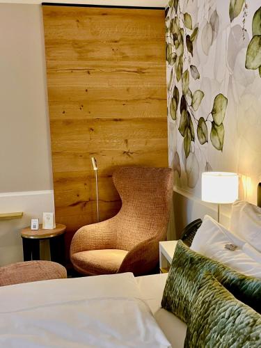 a hotel room with a bed and a chair at Best Western Premier Park Hotel & Spa in Bad Lippspringe
