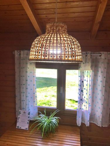 a window in a room with a wicker chandelier at Camping Gran Sol in Montferrer