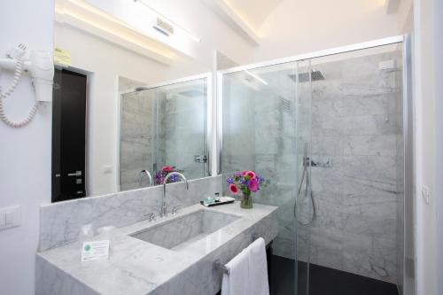 a bathroom with a large sink and a shower at Casual Rinascimento Firenze in Florence