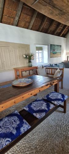 a living room with a large wooden table in a room at Casa Pescador Beach House in Struisbaai