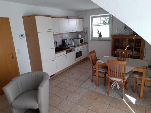 a kitchen and dining room with a table and chairs at Boddenkieker 04 in Zingst