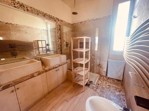 a bathroom with two sinks and a mirror at Residence Conchiglia Aparthotel in Alassio